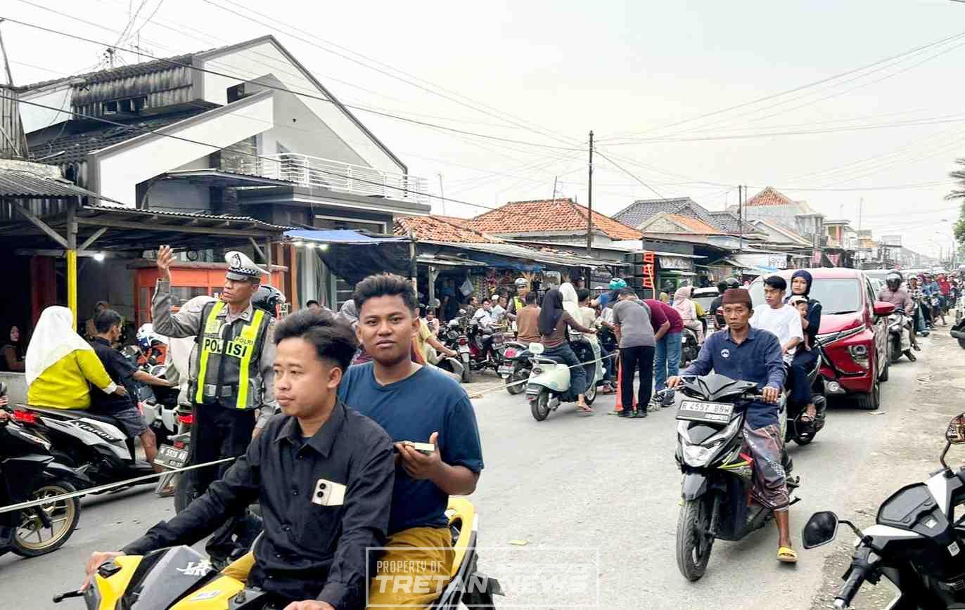 Petugas polisi mengatur lalu lintas saat tradisi Per-Peran di Desa Bandaran, Kecamatan Tlanakan, Kabupaten Pamekasan.